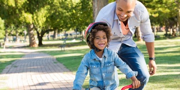 Child and father riding a bicycle