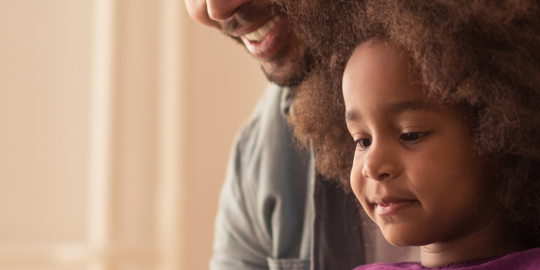 man and child on computer