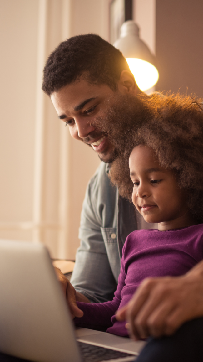 man and child on computer