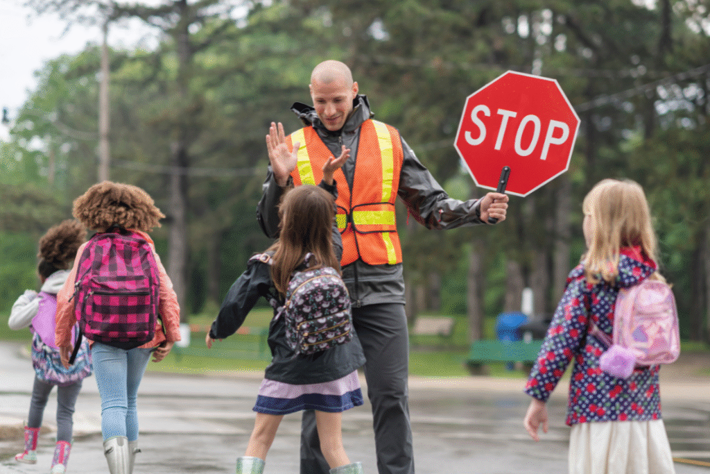 Crossing guard escorting children across road