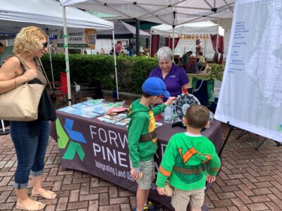Gulf Coast Fest 2026_Forward Pinellas (3) a woman and two young boys looking at a booth and map