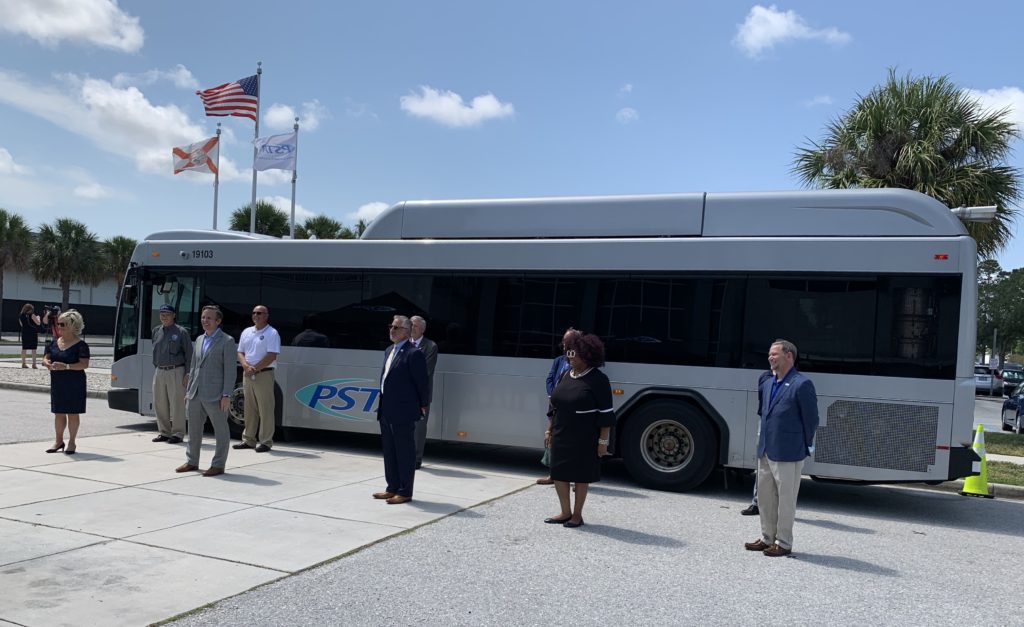 Whit Blanton and speakers in front of a PSTA bus