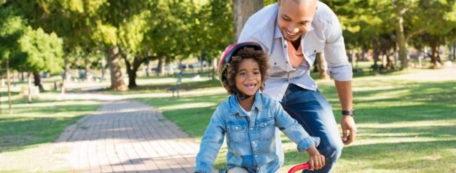 Child and father riding a bicycle