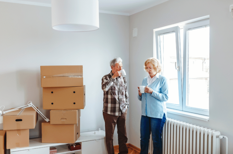 male and female senior in home with moving boxes