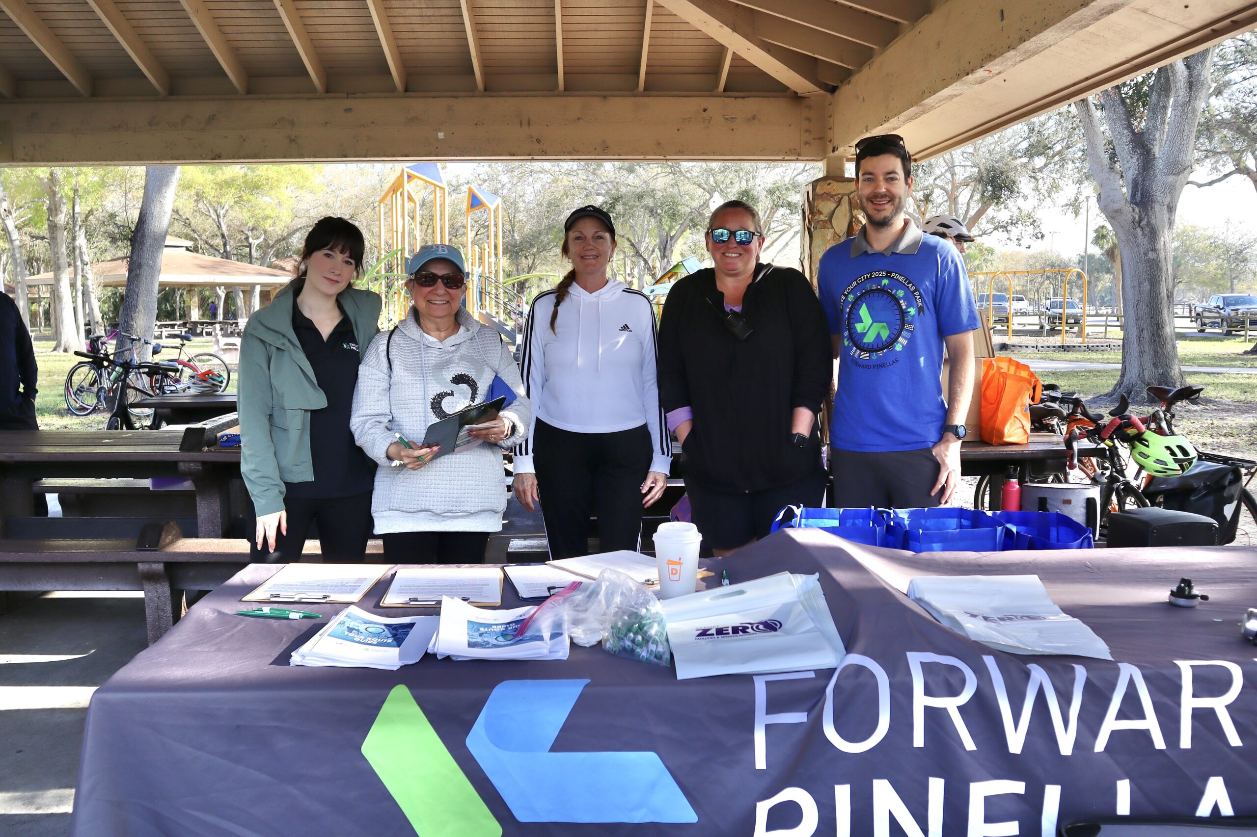 five people standing at booth