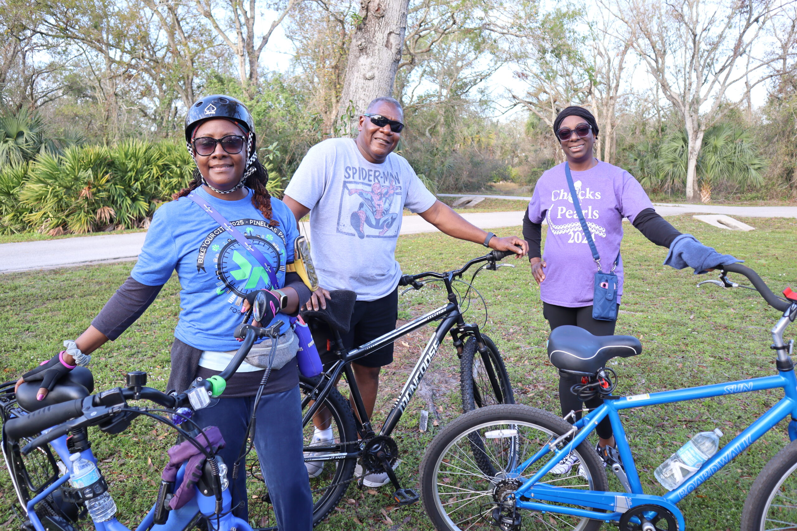 three people with bikes