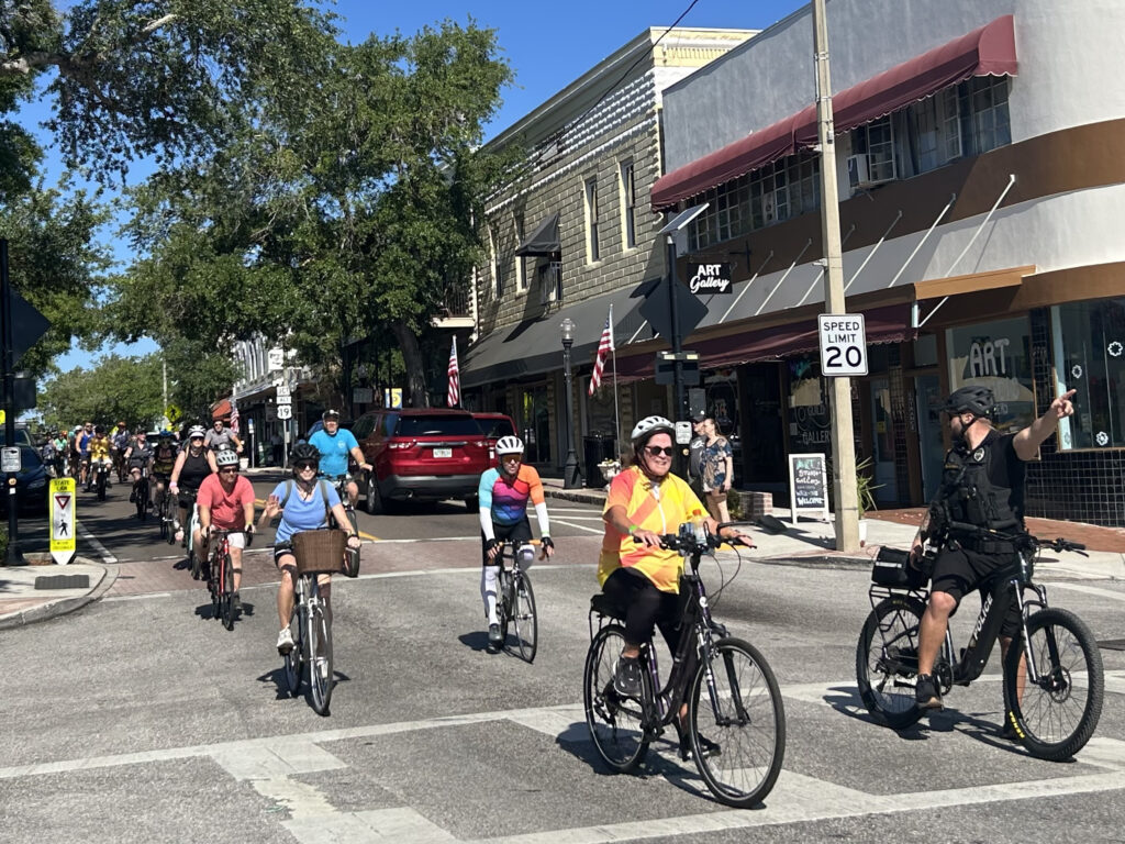 a group of people biking through a downtown street